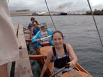 Click to enlarge smiling travelers on Captain Kiko's double canoe